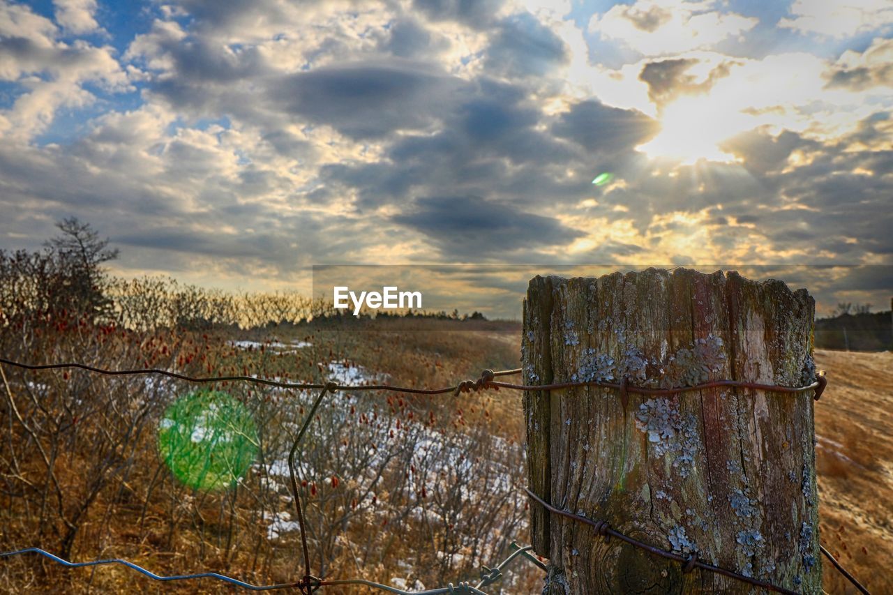 VIEW OF LANDSCAPE AGAINST SUNSET SKY