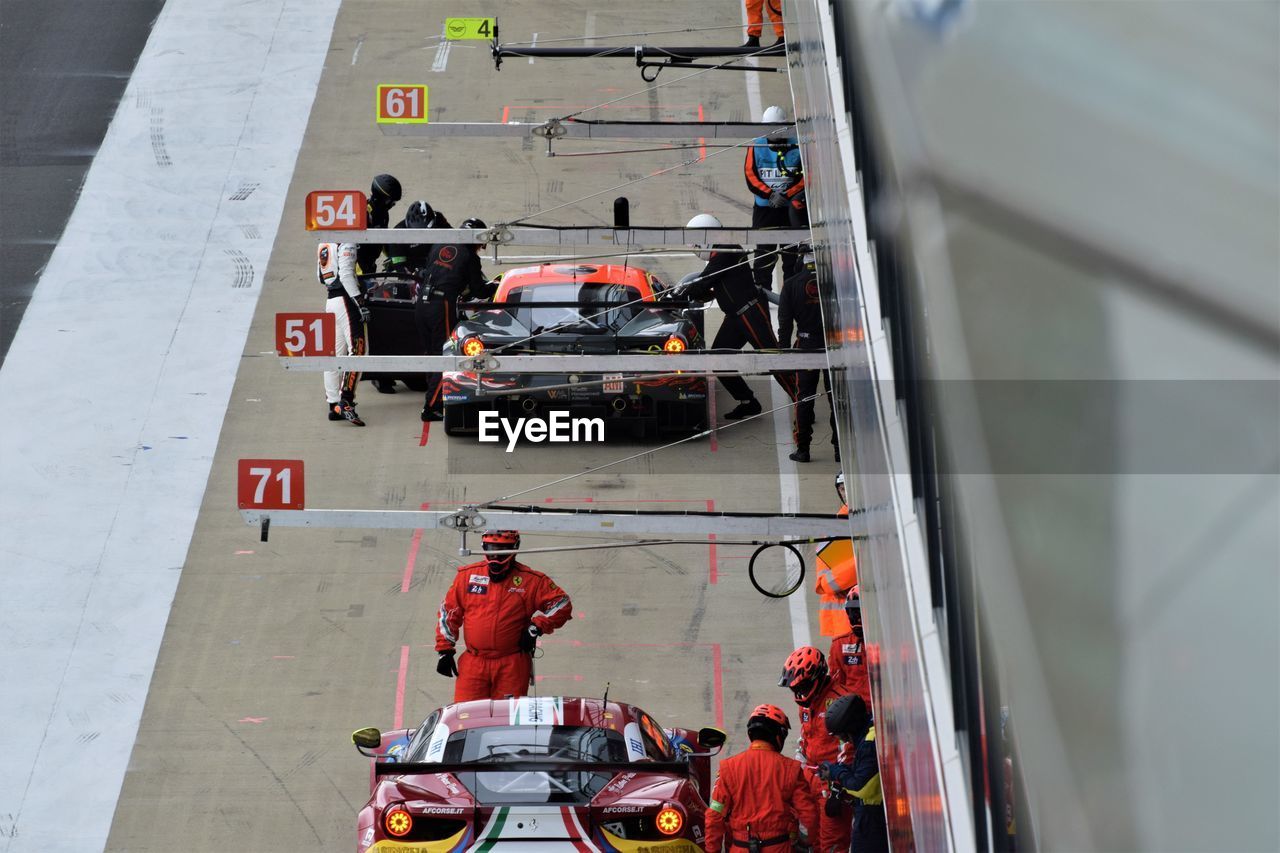 HIGH ANGLE VIEW OF PEOPLE ON CAR