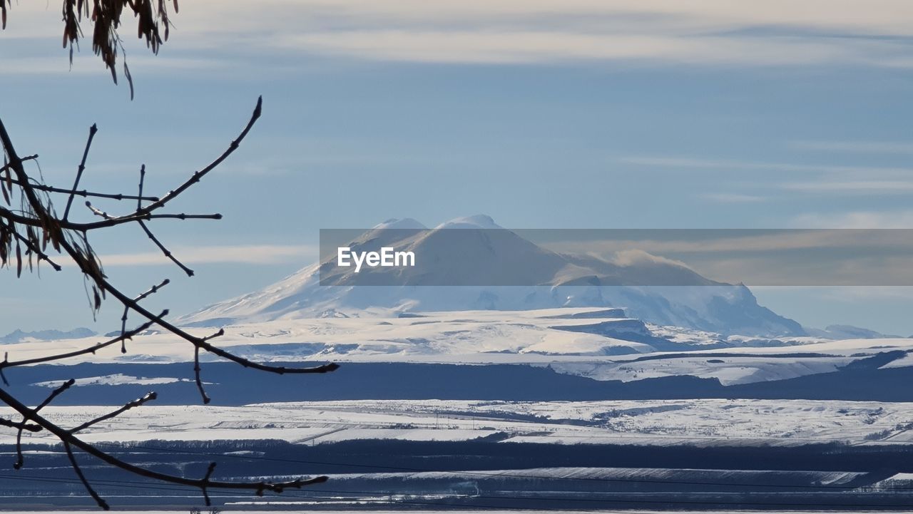 SNOW COVERED MOUNTAIN AGAINST SKY