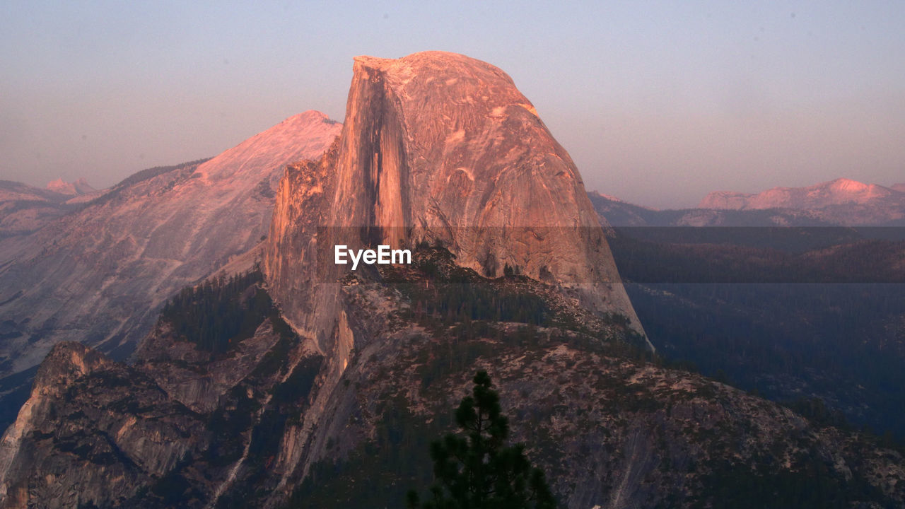 Panoramic view of rock formation against sky during sunset