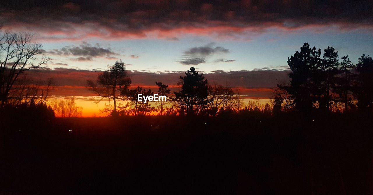 SCENIC VIEW OF SILHOUETTE LANDSCAPE AGAINST DRAMATIC SKY