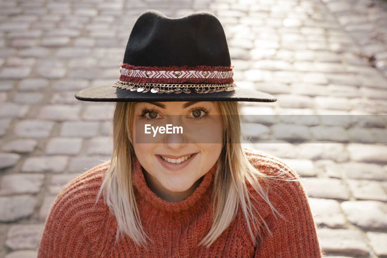 Portrait of young woman wearing hat