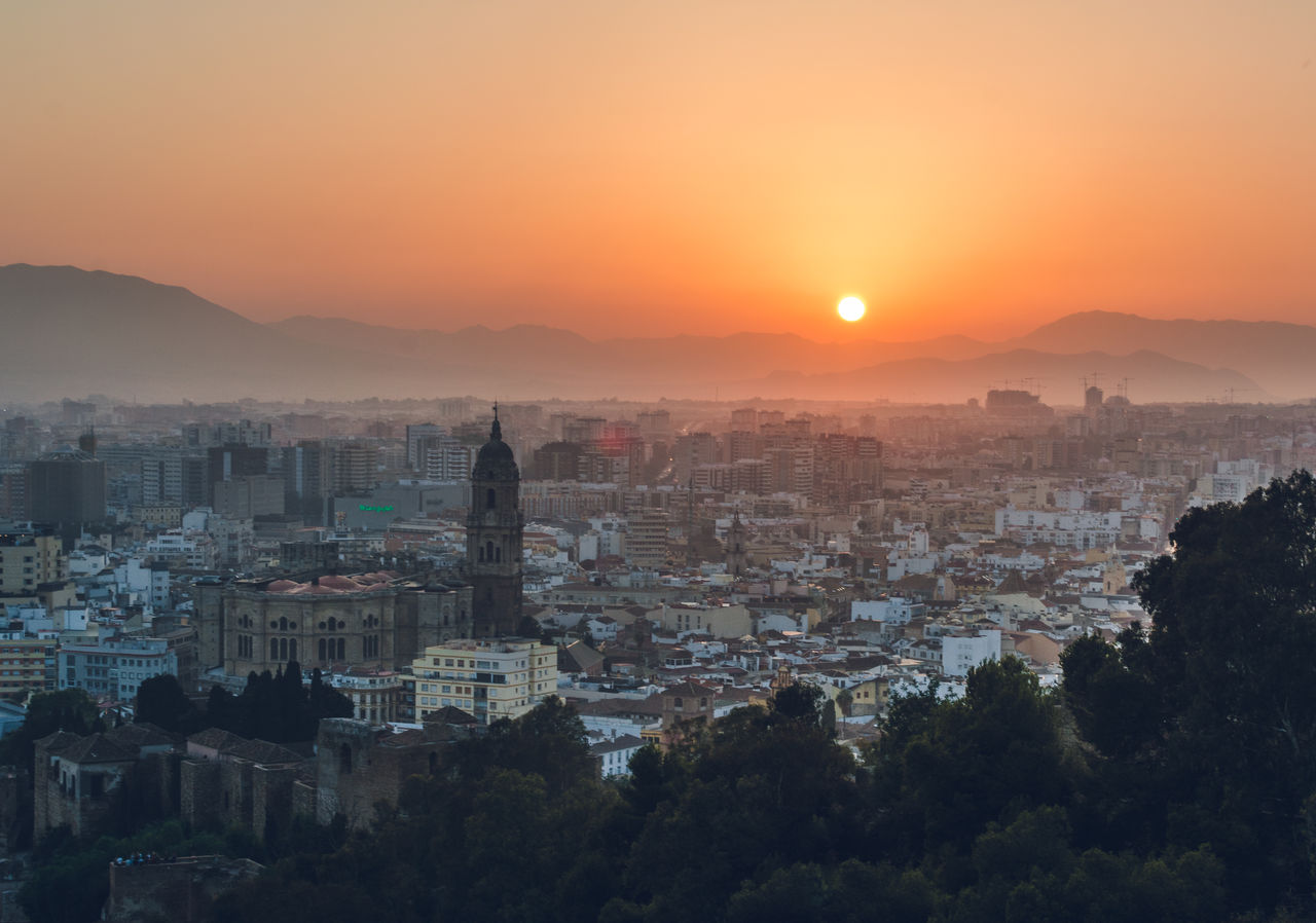 BUILDINGS IN CITY AT SUNSET