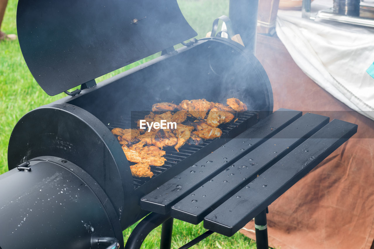 High angle view of meat on barbecue grill