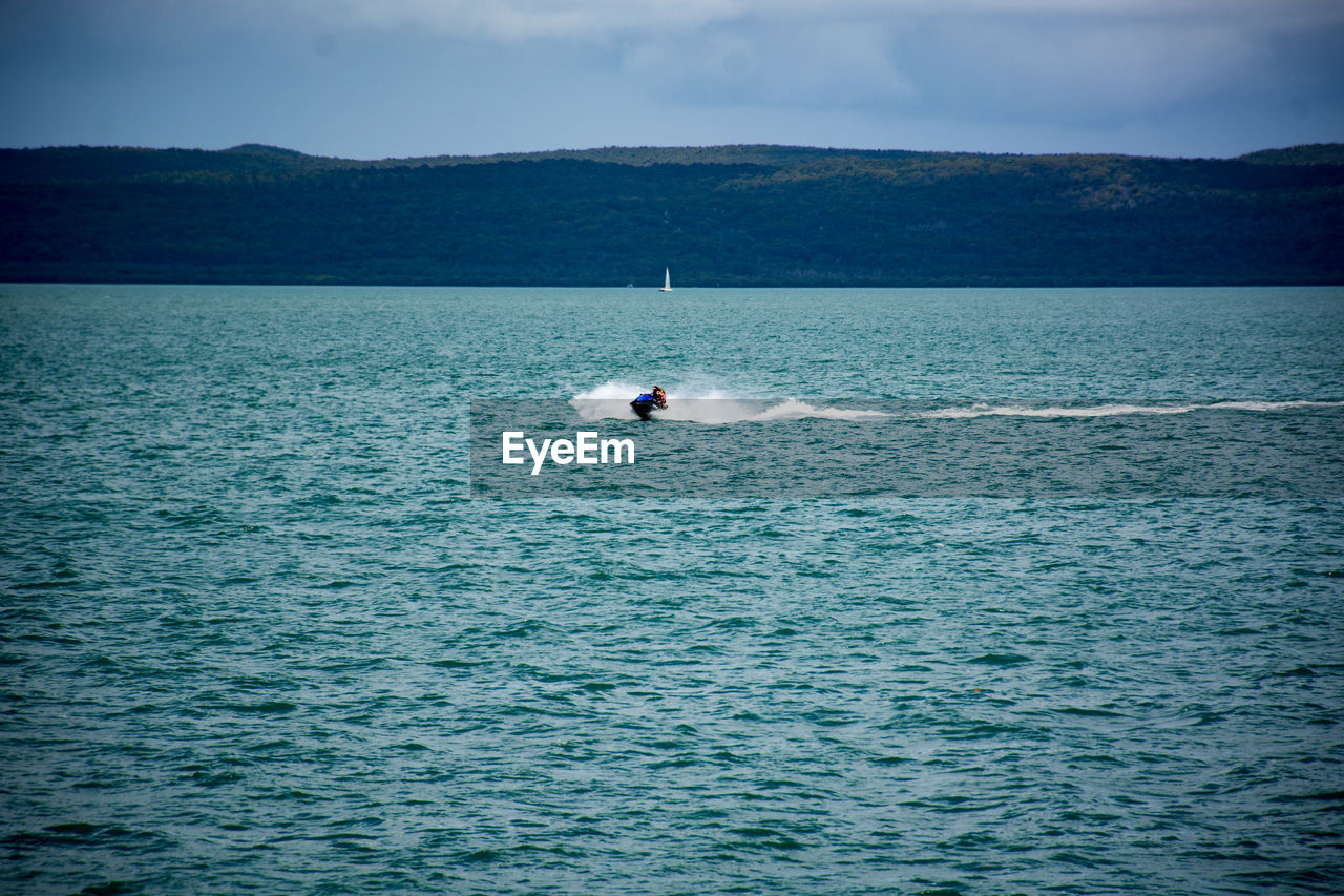 BOAT IN SEA AGAINST SKY