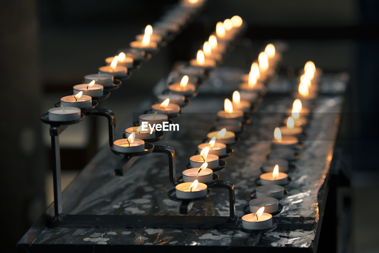 ILLUMINATED CANDLES IN TEMPLE