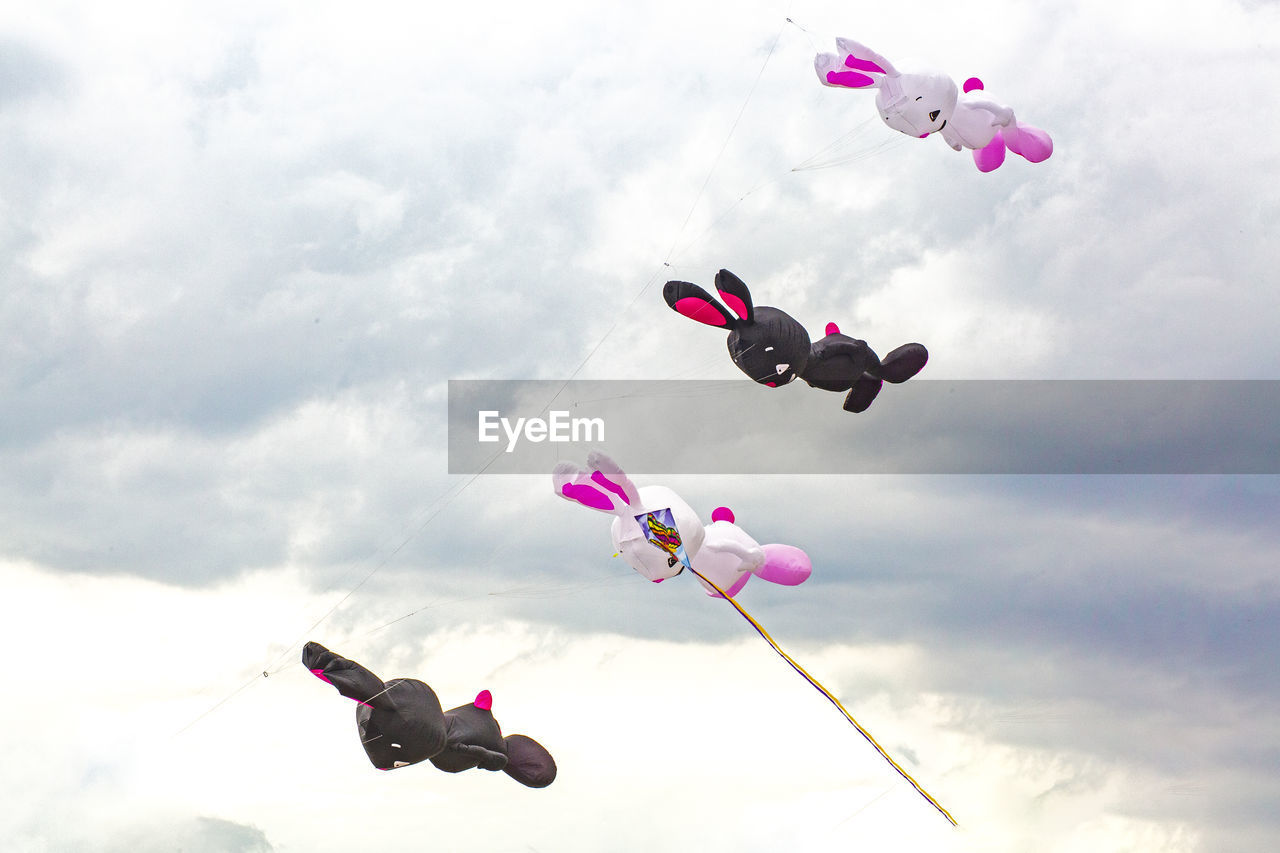 flying, cloud, mid-air, sky, windsports, nature, kite sports, sports, toy, motion, day, pink, flower, kite - toy, extreme sports, parachuting, childhood, outdoors, positive emotion, low angle view, kite, fun, multi colored, emotion, leisure activity, falling, balloon