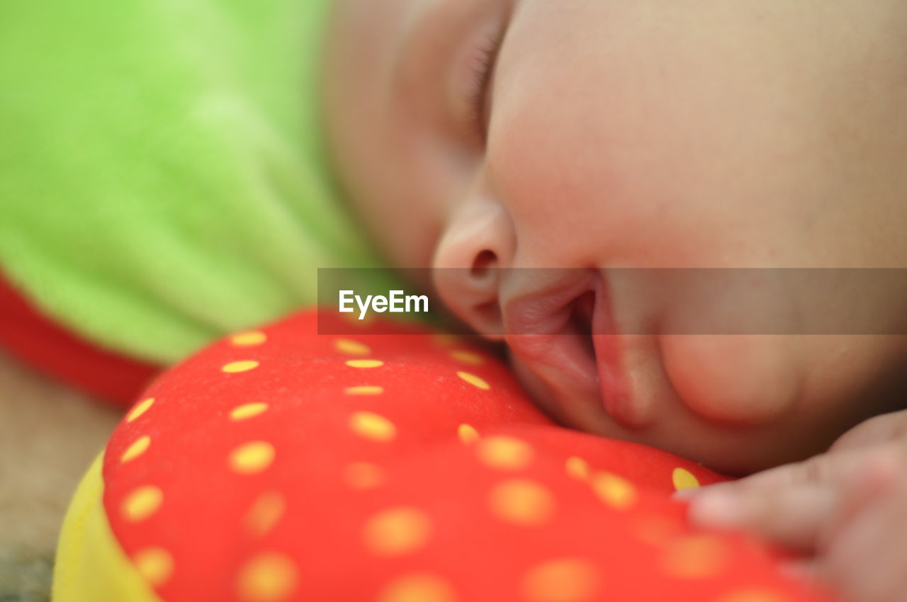 Close-up of baby boy sleeping on pillow