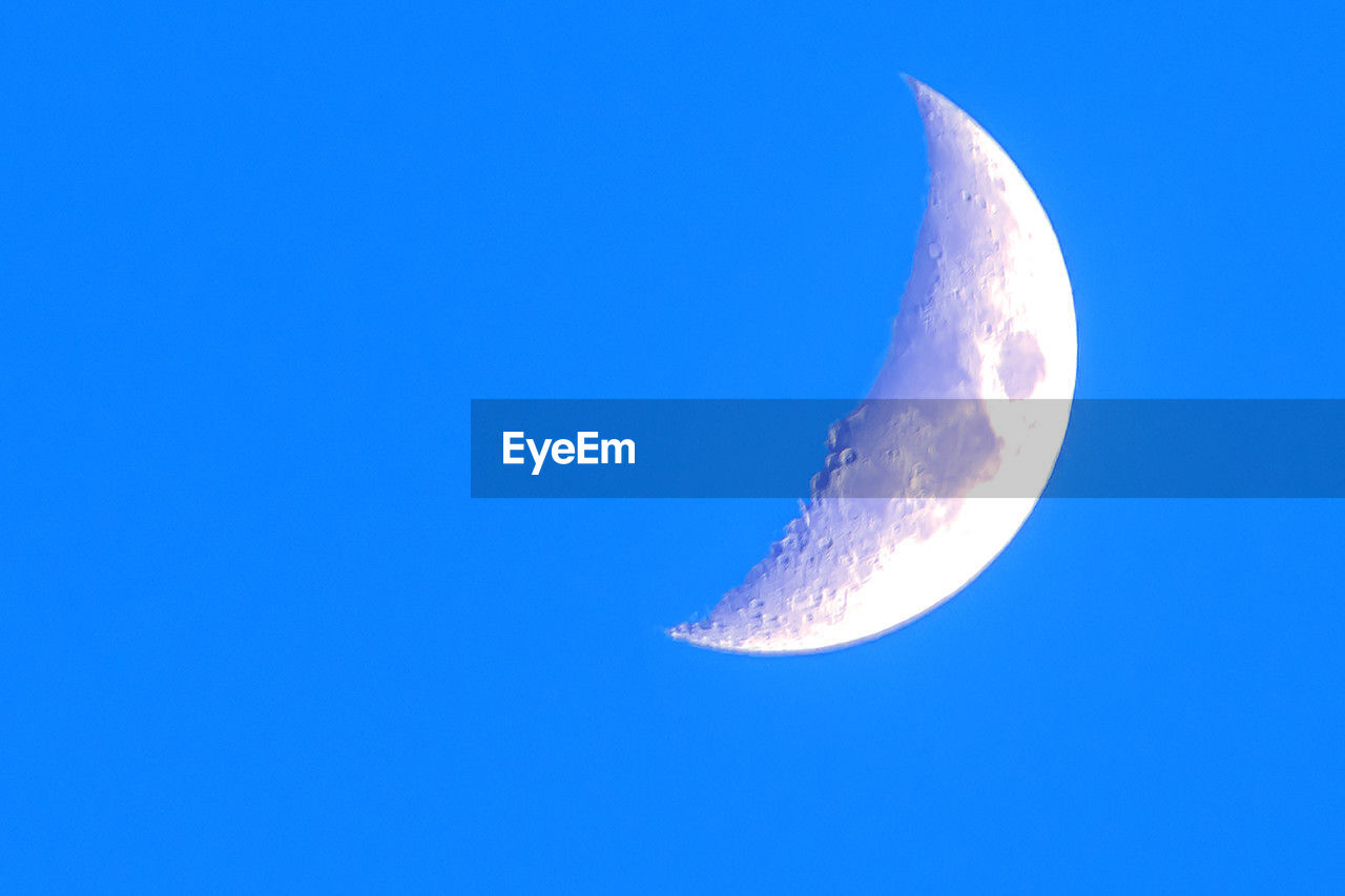 sky, moon, space, blue, astronomy, beauty in nature, half moon, crescent, nature, copy space, no people, clear sky, night, tranquility, low angle view, moon surface, scenics - nature, tranquil scene, astrology, outdoors, planetary moon, idyllic, space exploration