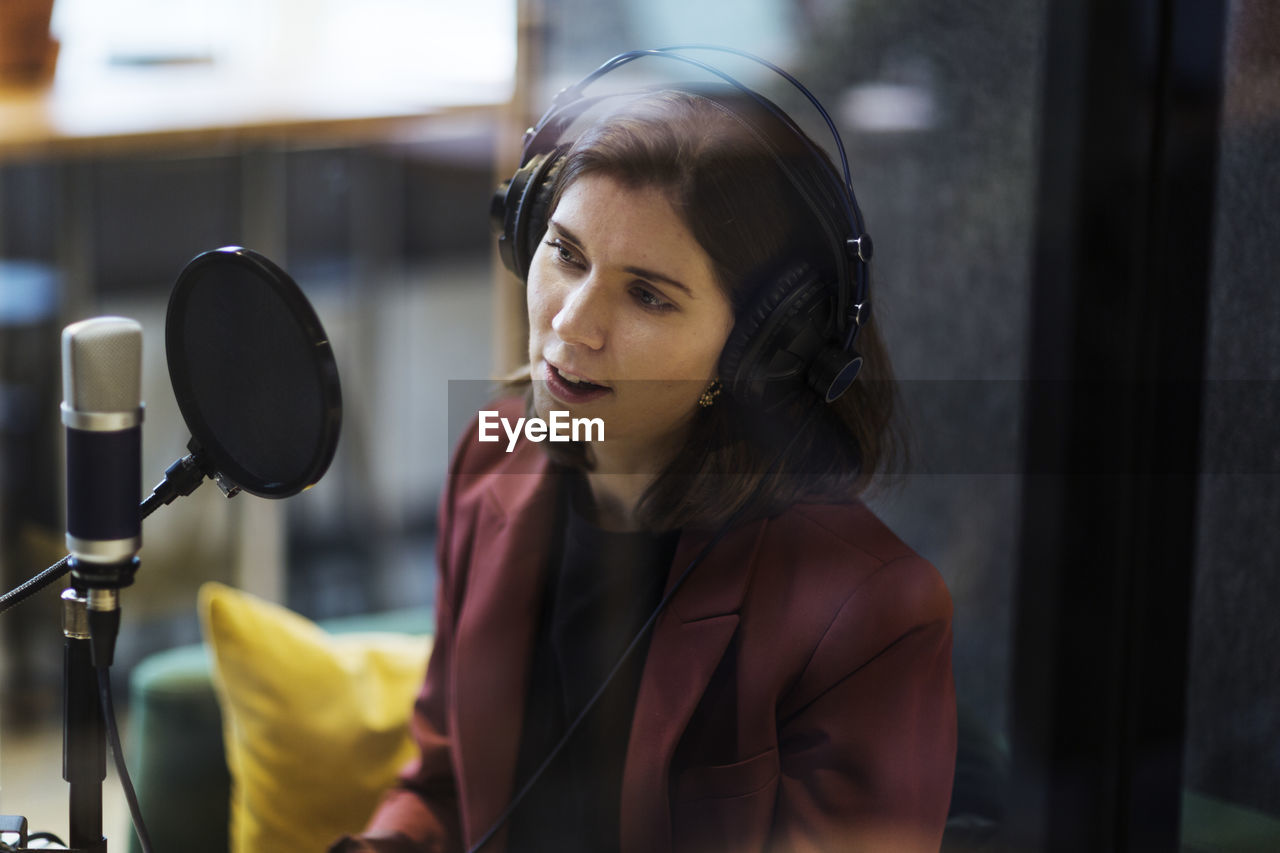 Woman broadcasting from radio station