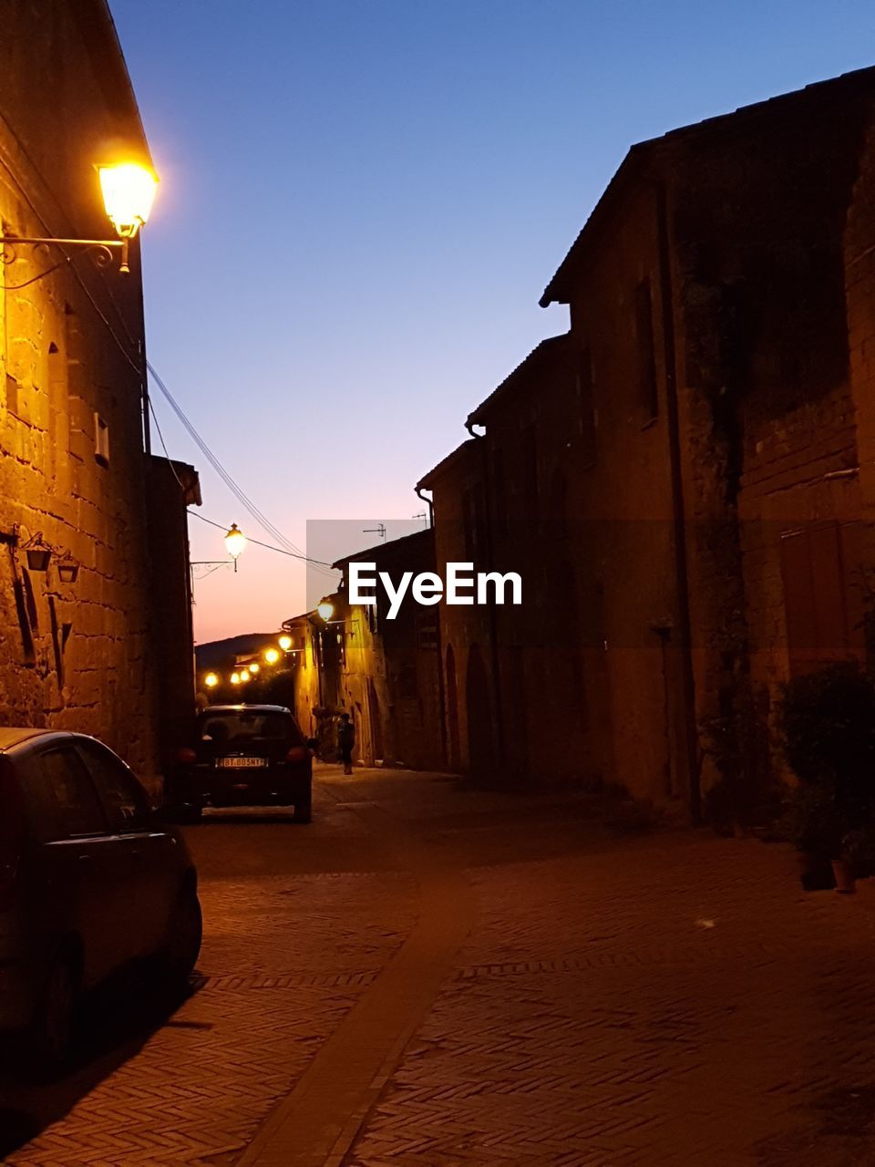 CARS PARKED ON STREET AGAINST HOUSES