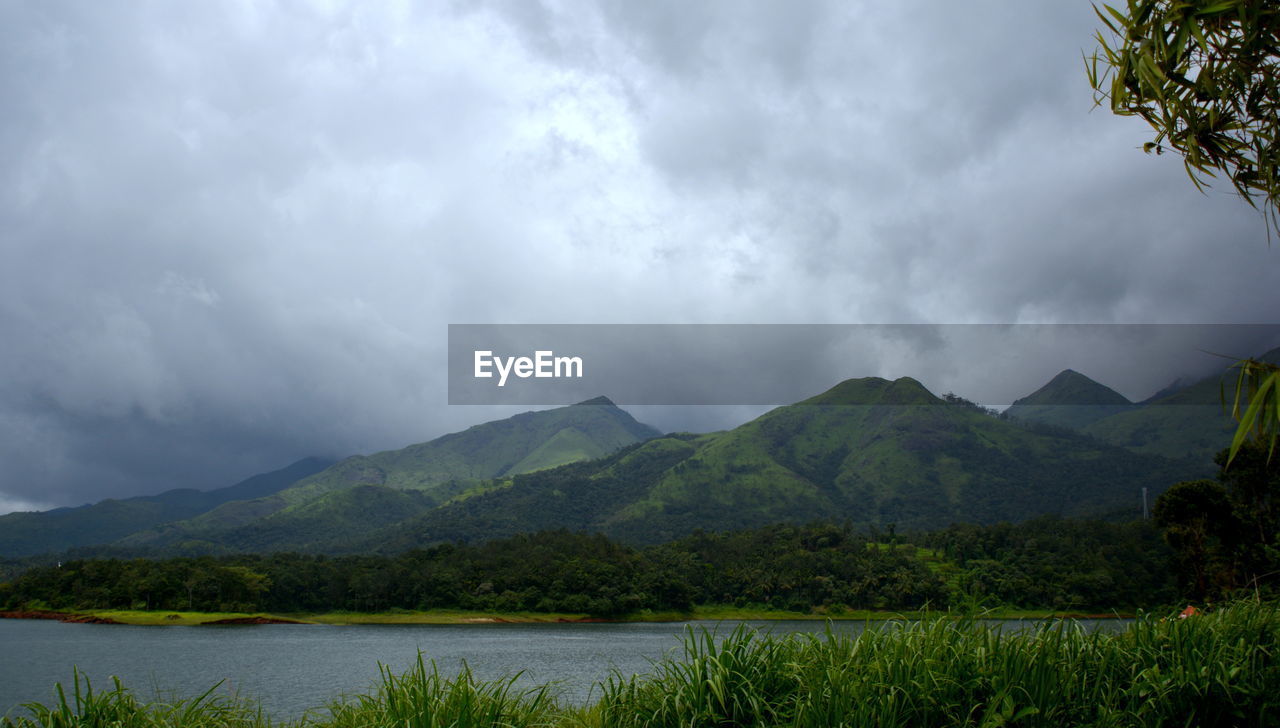 SCENIC VIEW OF MOUNTAINS AGAINST CLOUDY SKY