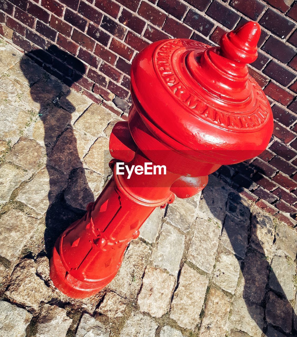 HIGH ANGLE VIEW OF FIRE HYDRANT ON SIDEWALK