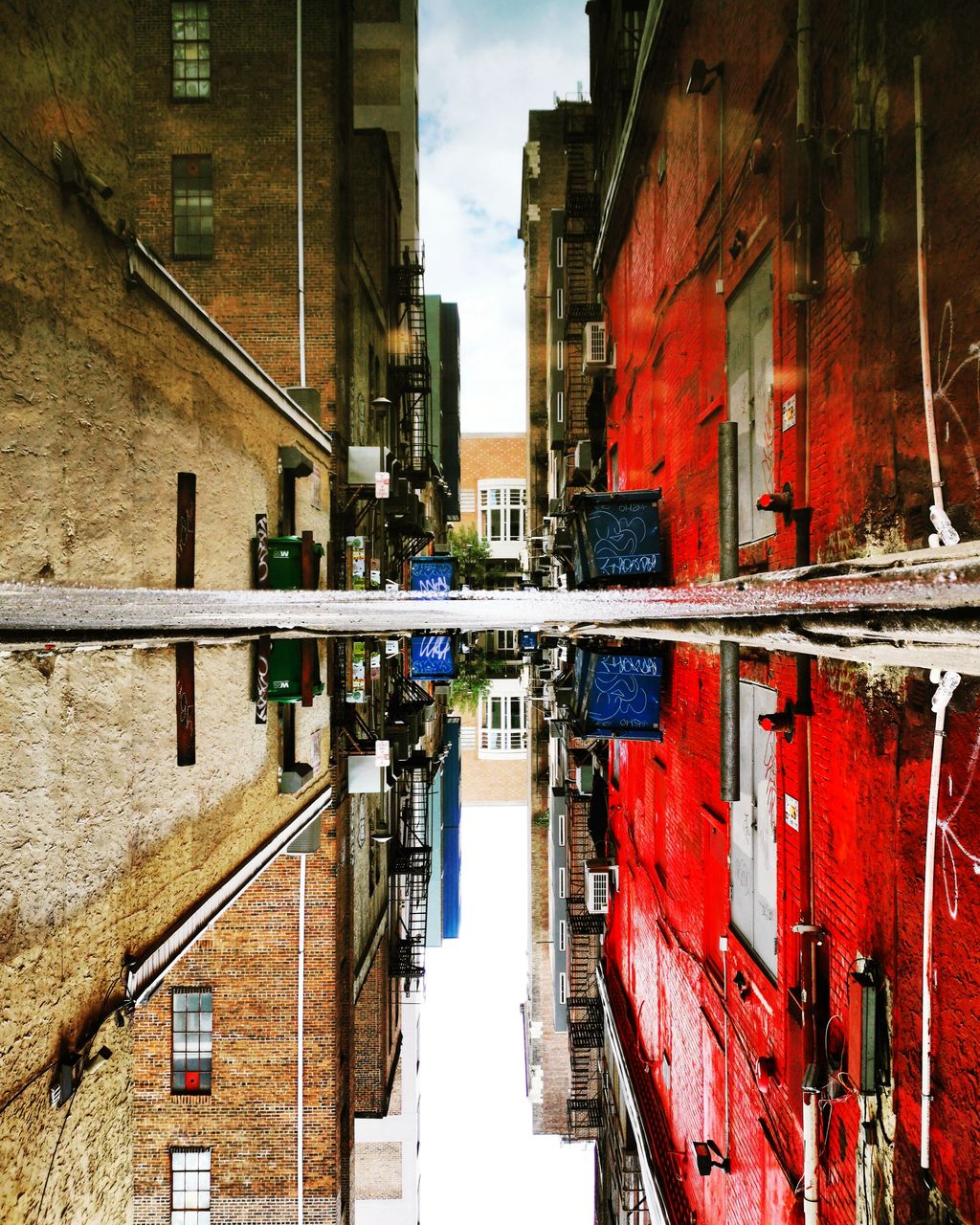 Reflection of buildings in puddle on street