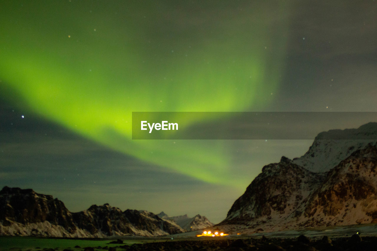 Scenic view of illuminated mountain against sky at night