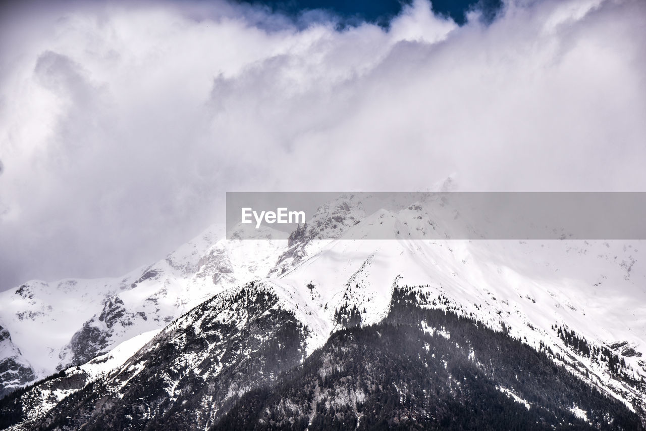 Scenic view of snow covered mountains against sky