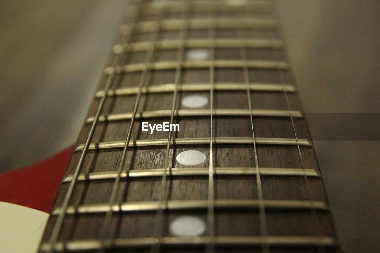CLOSE-UP OF GUITAR IN OFFICE BUILDING