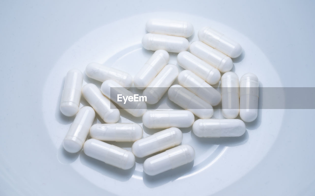 Close-up of pills on white background