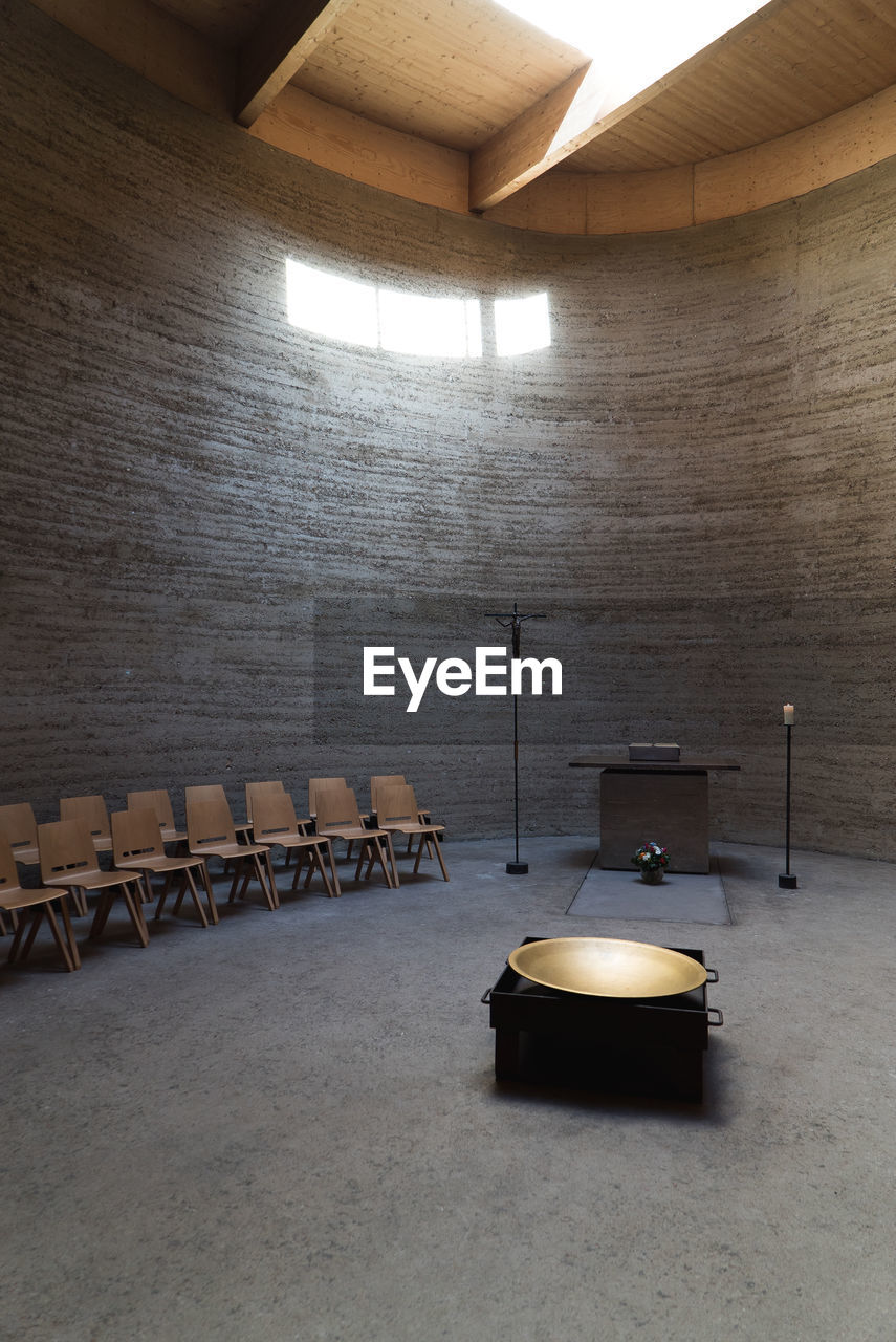 Empty chairs by altar in chapel
