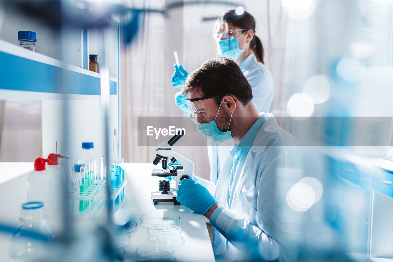side view of female doctor examining patient at laboratory