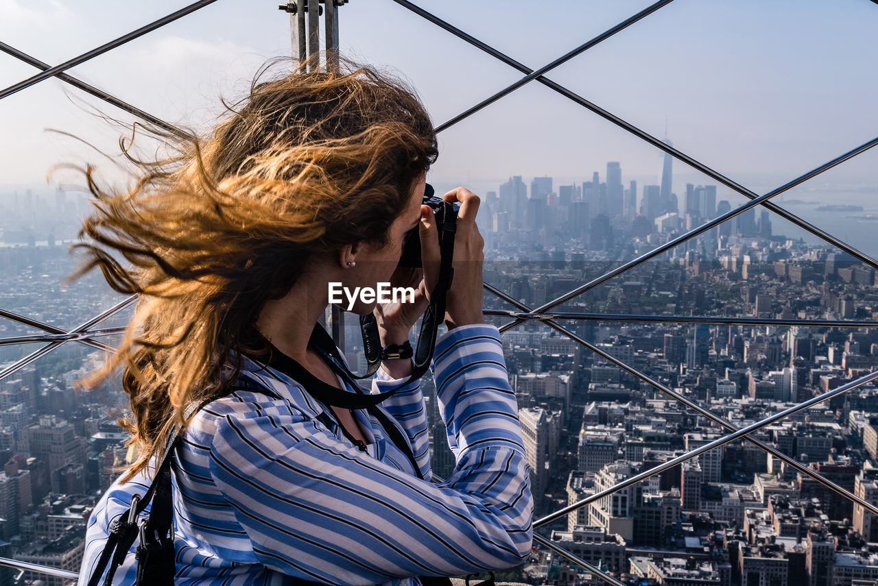 Woman photographing cityscape