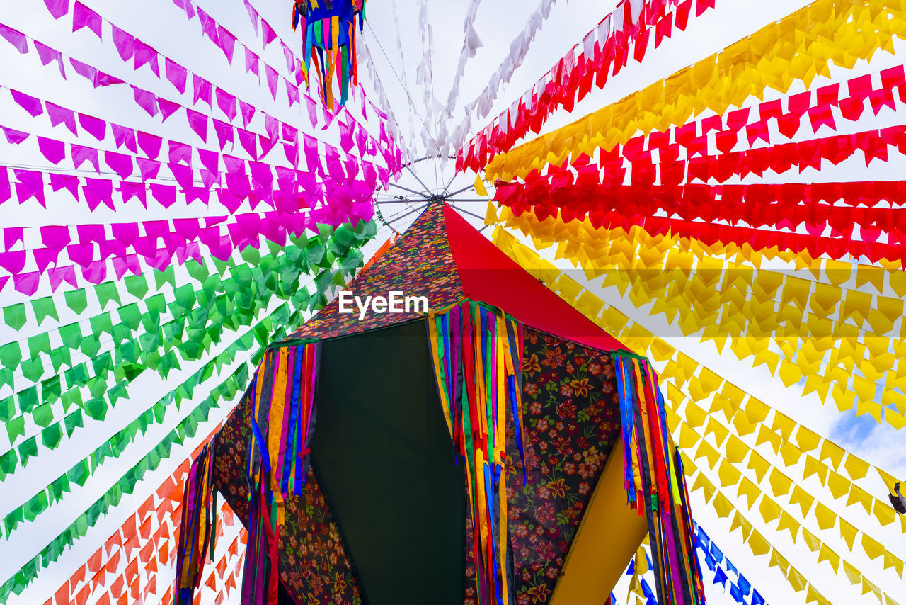 multi colored, decoration, pattern, no people, low angle view, hanging, tradition, celebration, line, architecture, event, backgrounds, outdoors, lighting equipment, built structure