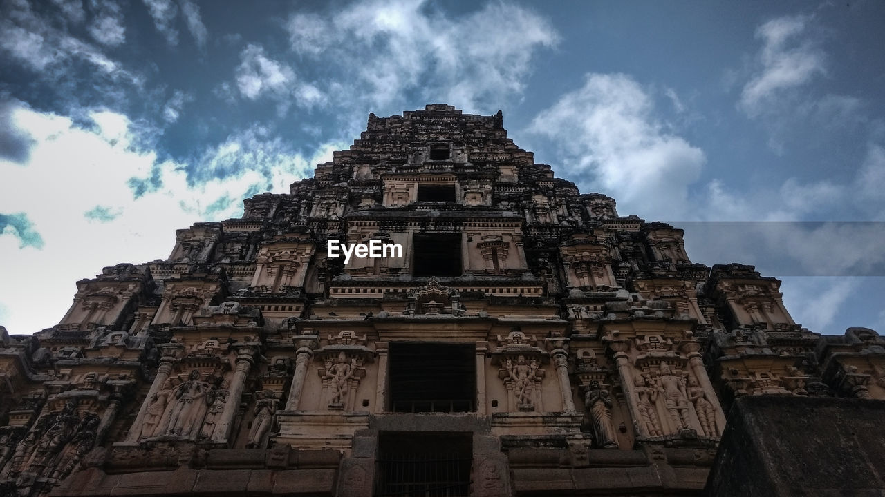 Low angle view of temple against clouds