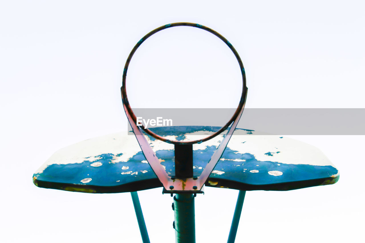LOW ANGLE VIEW OF BASKETBALL HOOP AGAINST WHITE BACKGROUND