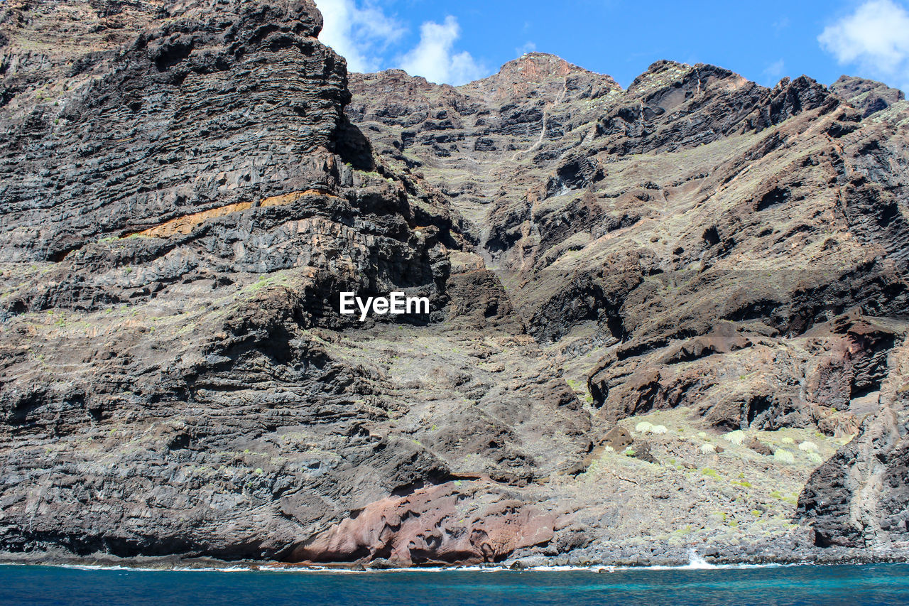 View on the steep coast of los gigantes on canary island tenerife with rocks in different colors