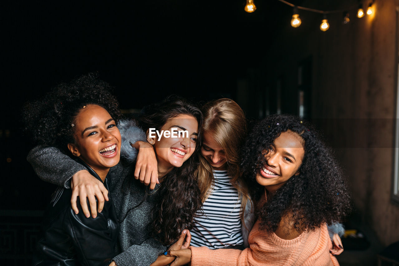 Happy female friends enjoying at night