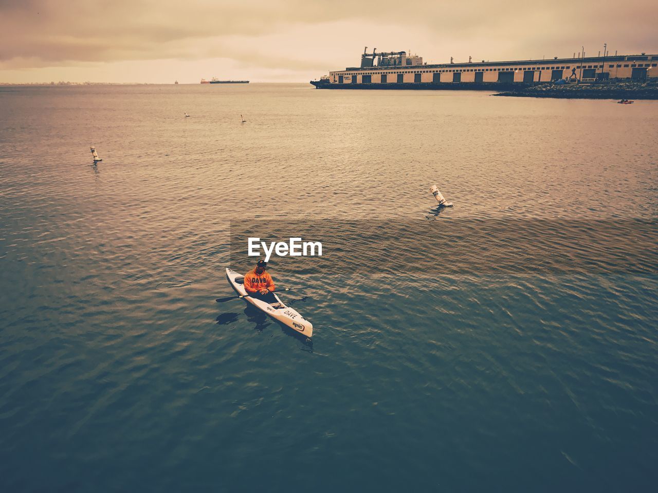 High angle view of man kayaking on sea against sky
