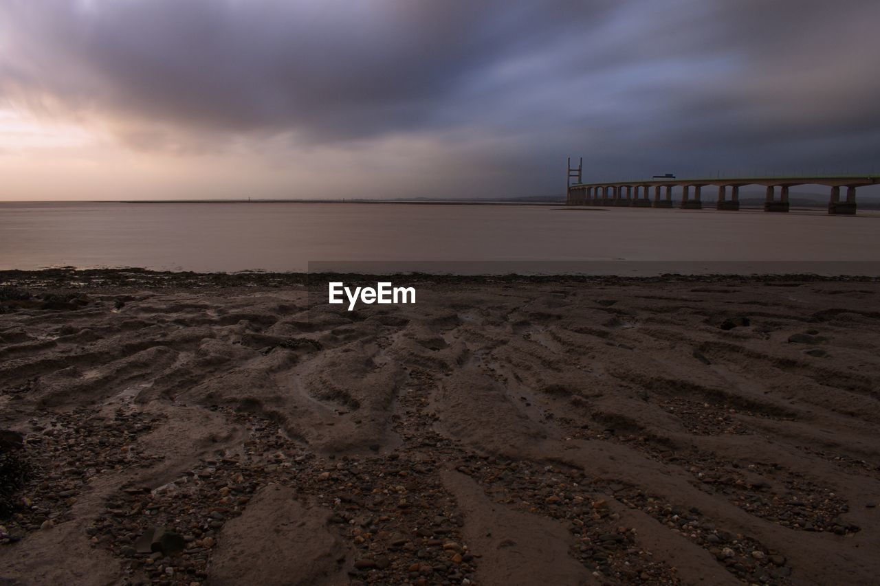 Scenic view of beach against sky during sunset