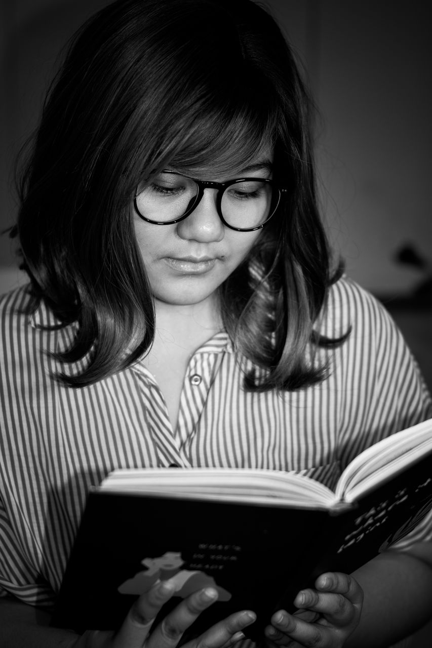 black, reading, glasses, black and white, publication, one person, book, eyeglasses, women, education, learning, vision care, adult, monochrome, white, portrait, monochrome photography, activity, person, studying, indoors, portrait photography, child, student, holding, intelligence, female, sitting, hairstyle, communication, looking, front view, casual clothing, young adult, childhood, long hair, looking down, lifestyles, reading glasses, concentration, emotion, smiling, photo shoot, wireless technology, striped, technology, digital tablet, wisdom