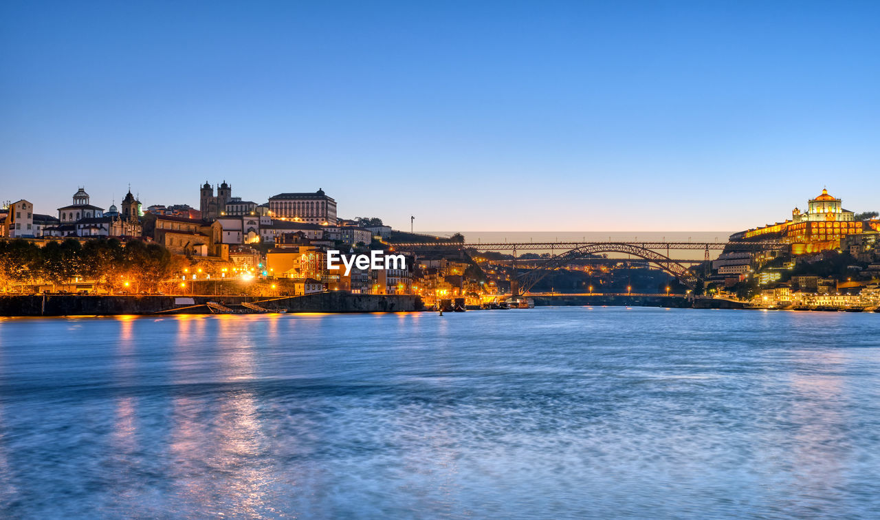 The river douro with the old town of porto in the back at dawn