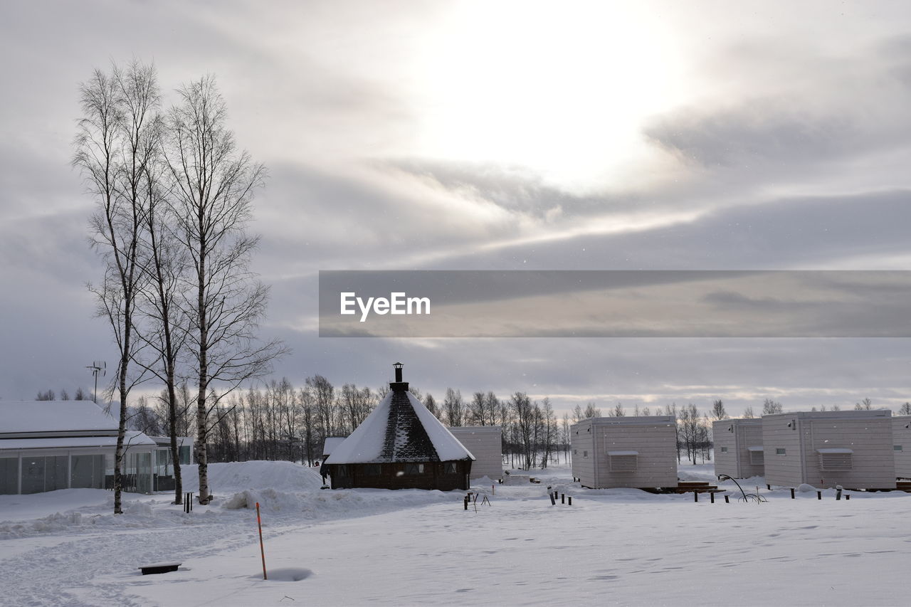 Scenic view of snow covered field against sky during sunset