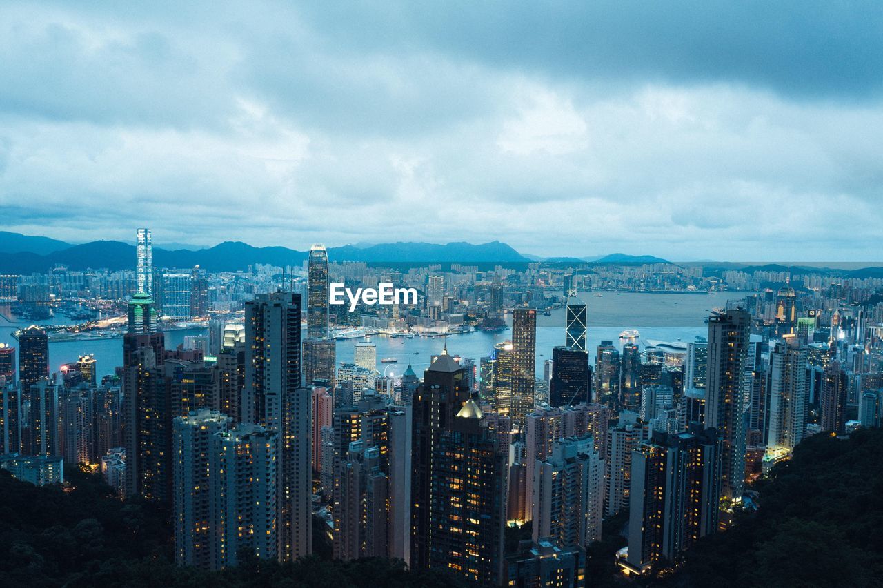 View of cityscape against cloudy sky