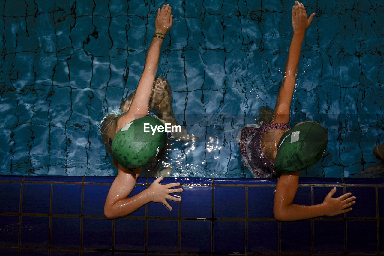 Directly above shot of boy and girl swimming in pool