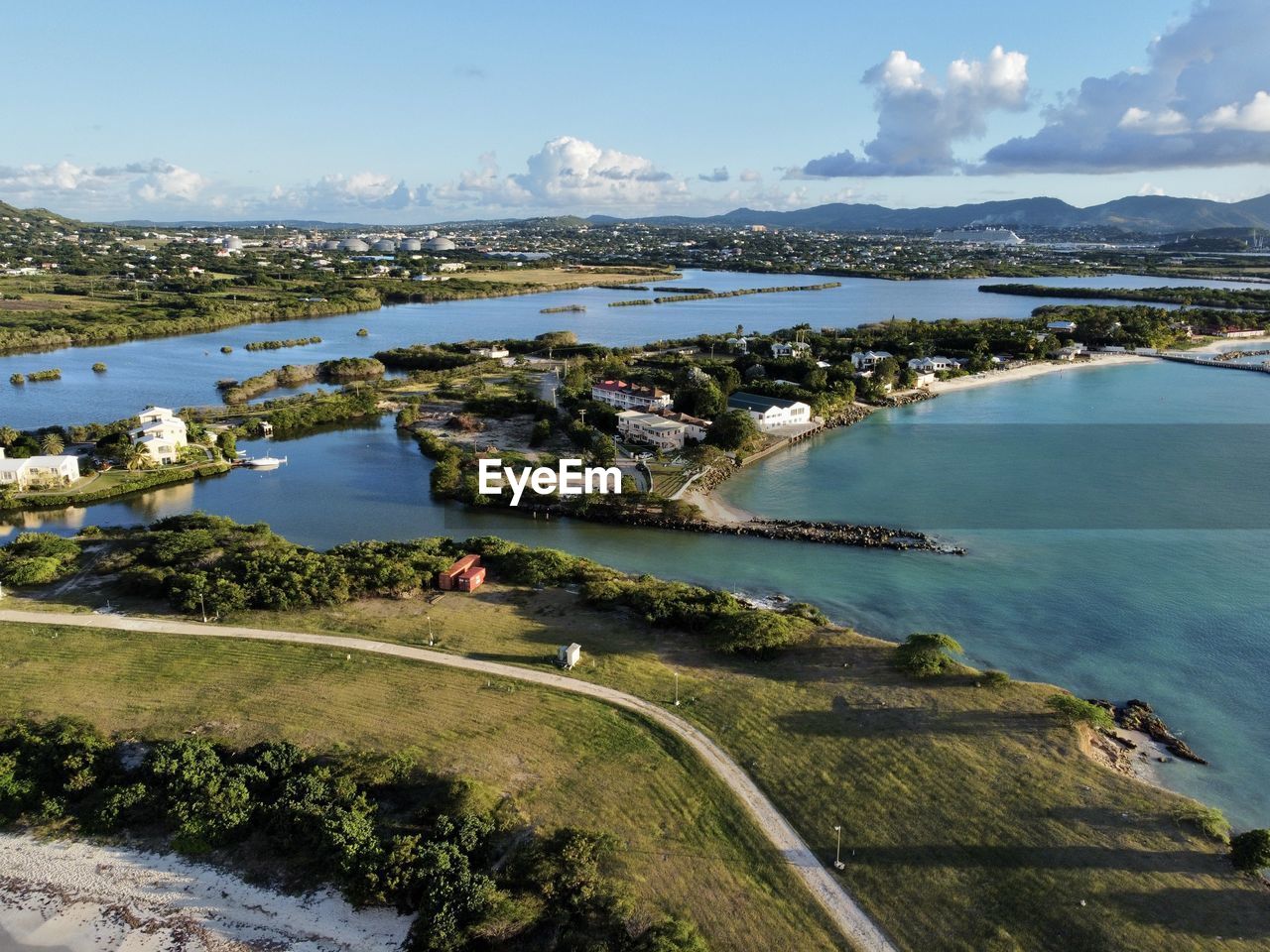 high angle view of city by sea against sky