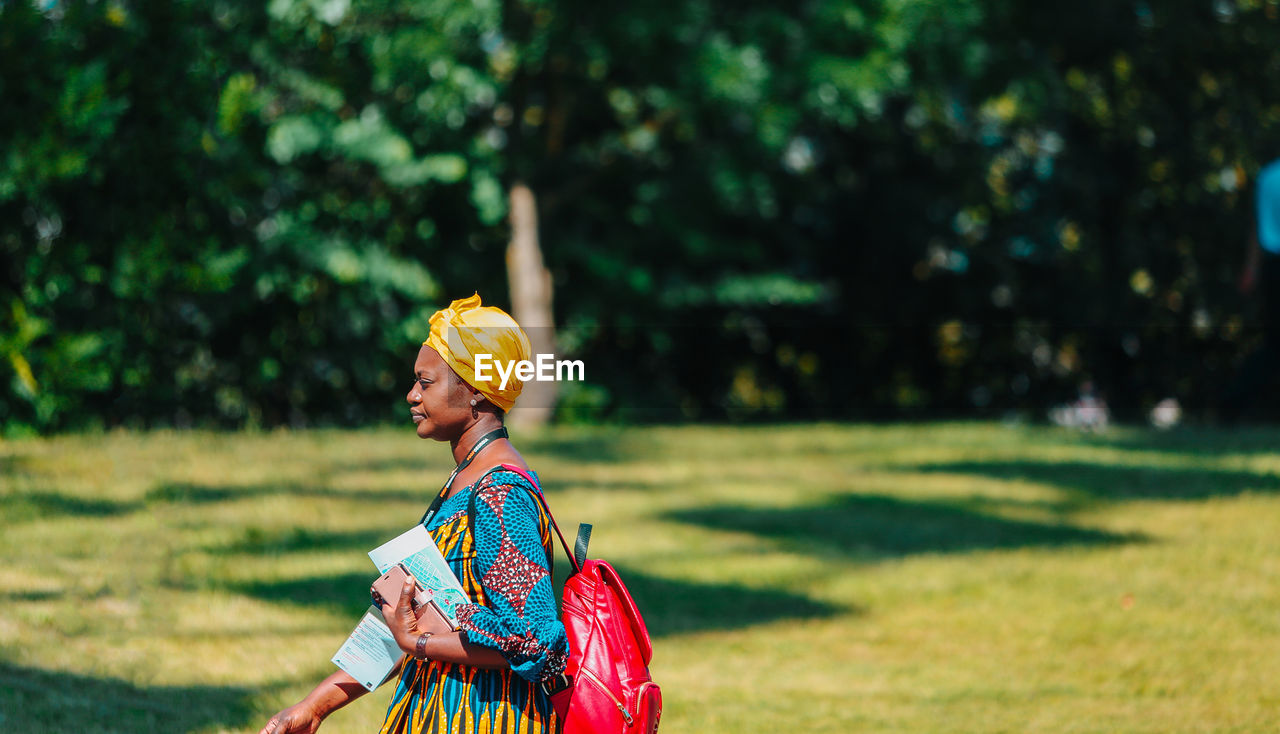 Side view of woman walking on field