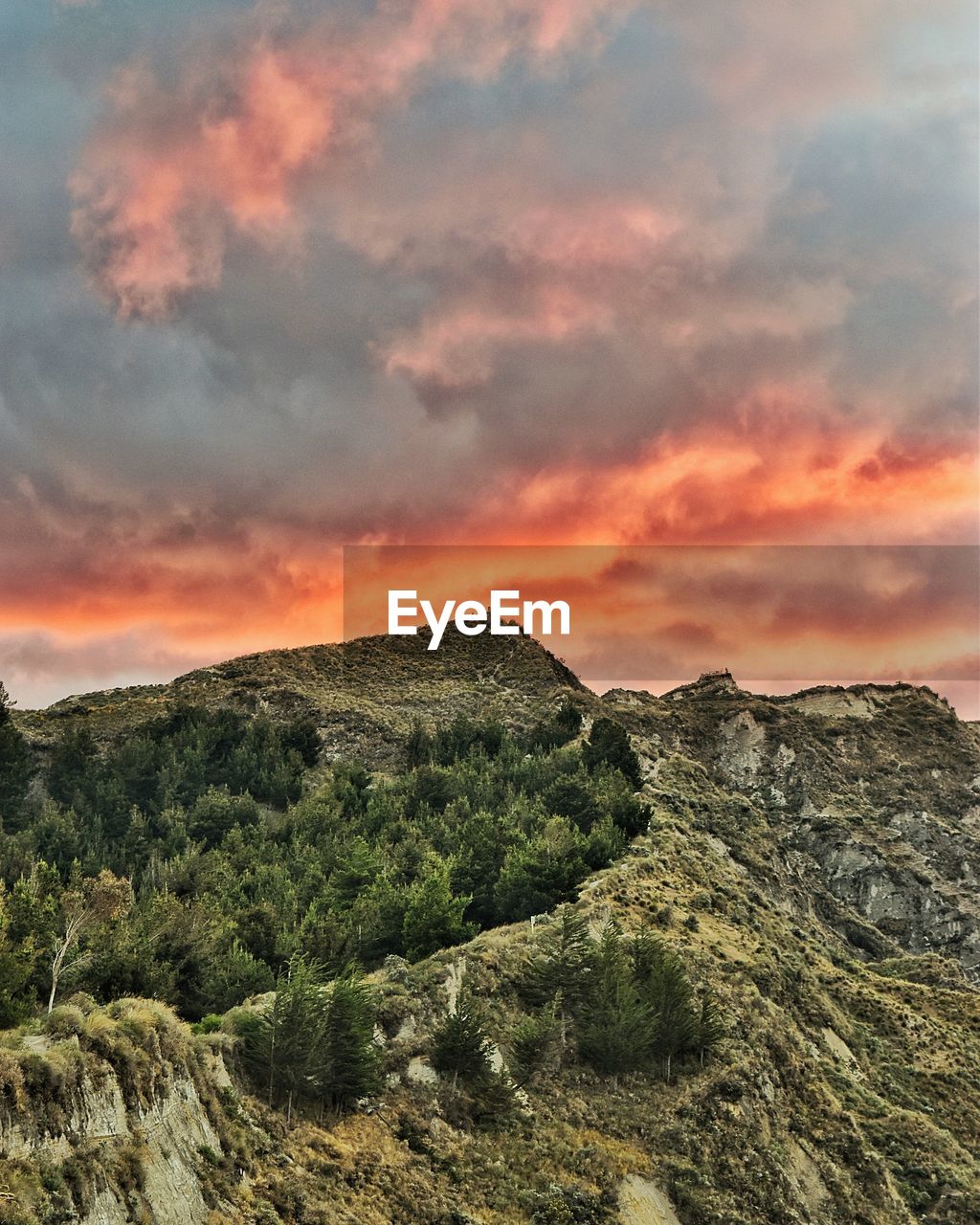 Scenic view of mountains against sky at sunset