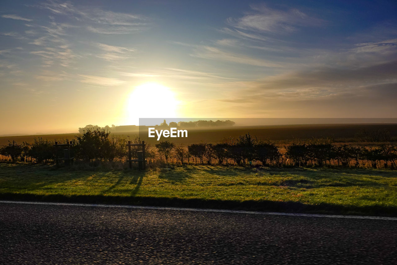 Scenic view of field against sky during sunset