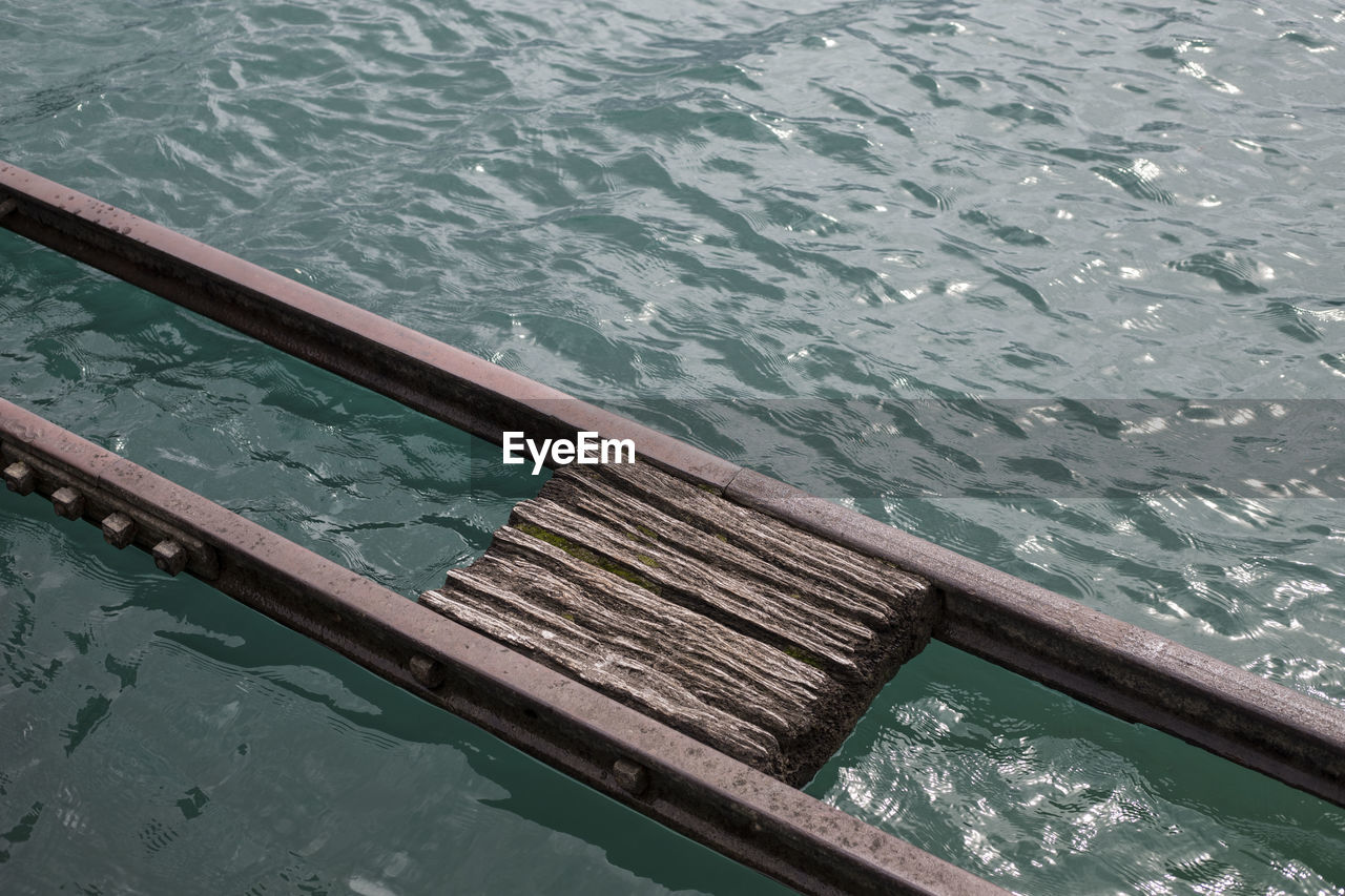 HIGH ANGLE VIEW OF SWIMMING POOL IN SEA