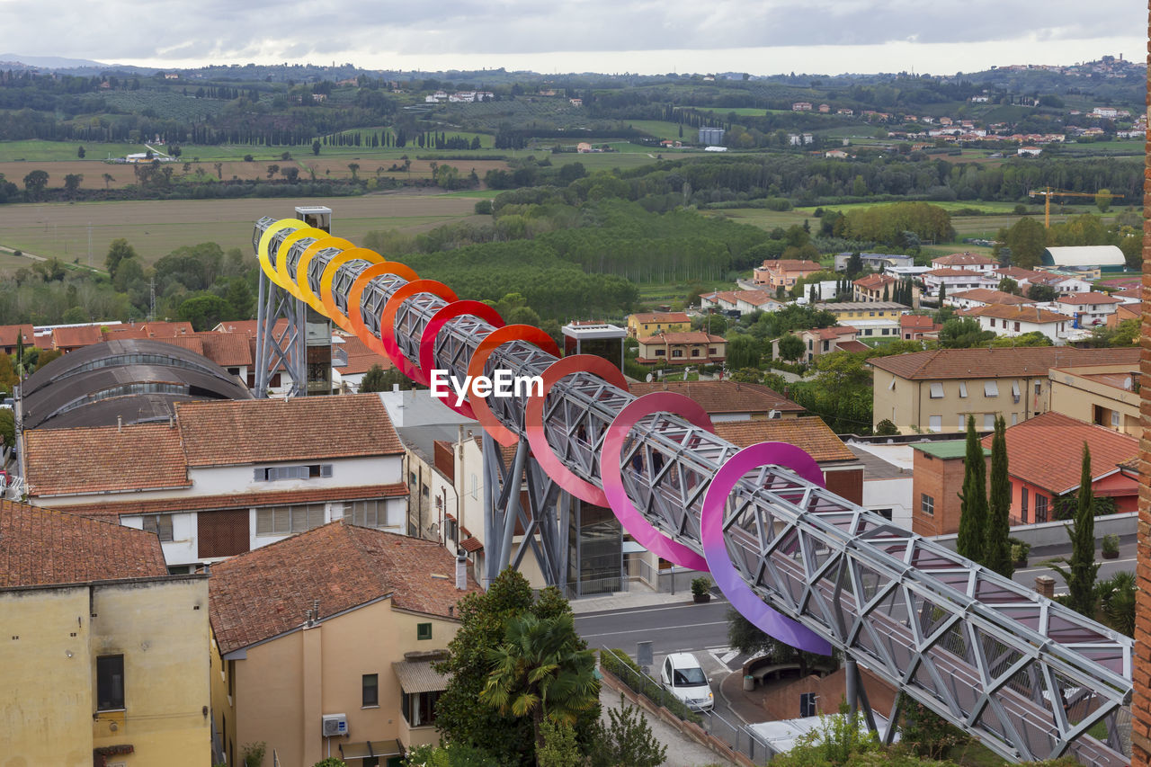 High angle view of the footbridge with colorful spiral against the landscape