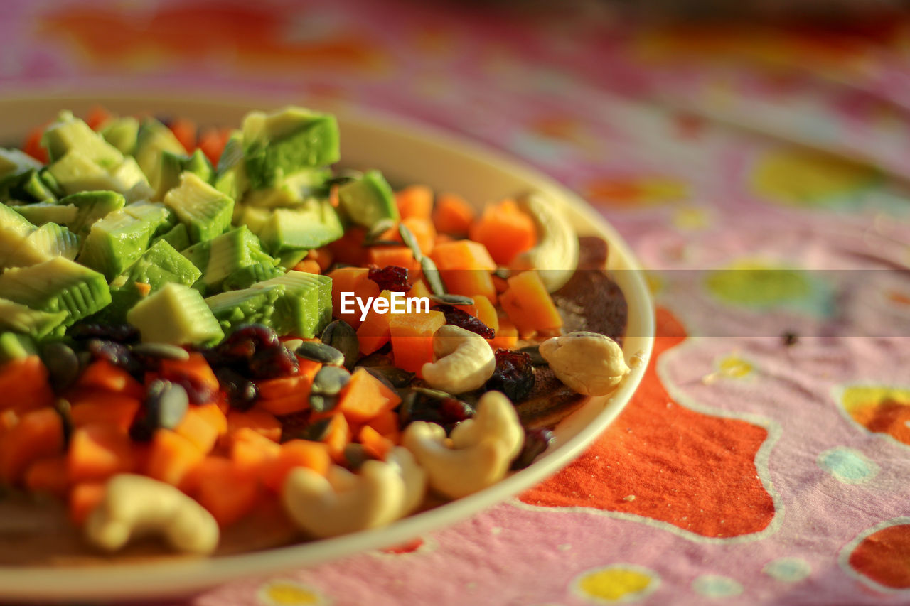 A special salad with avocado, cucumbers, and cashews is prepared to eat healthy and refreshing - b.s