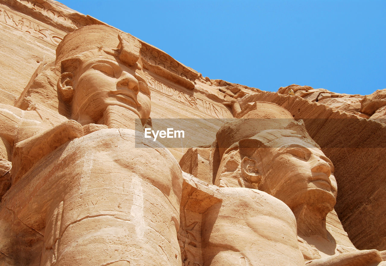 The colossal statues of ramesses ii in abu simbel. egypt