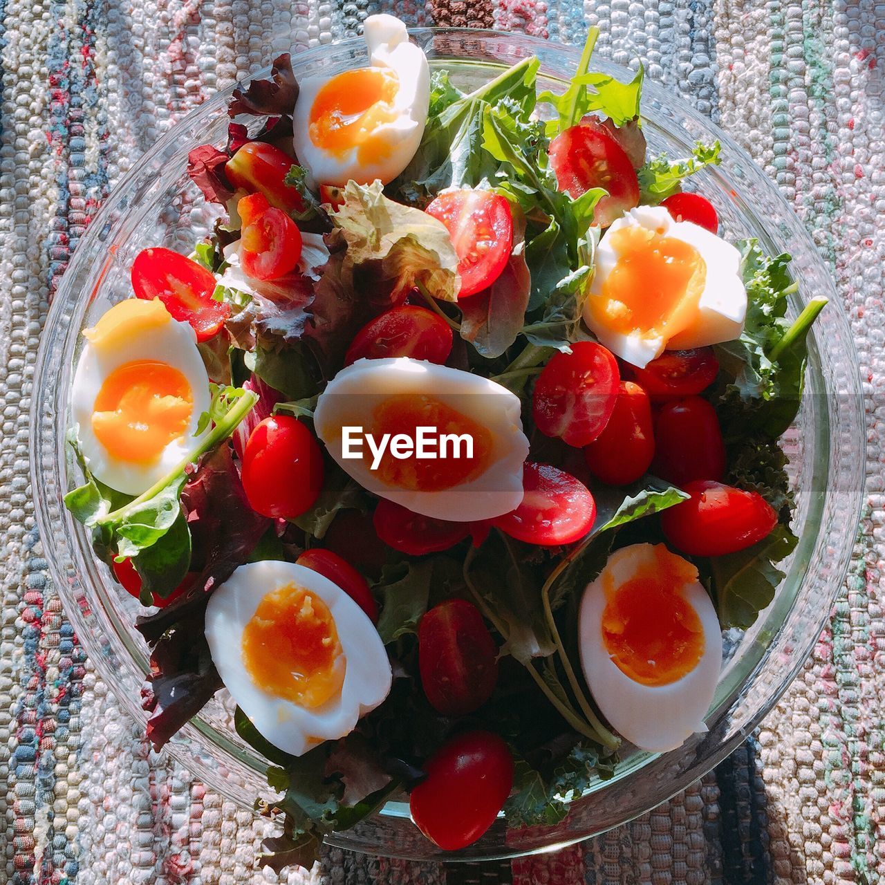 High angle view of eggs and salad in plate on table at home