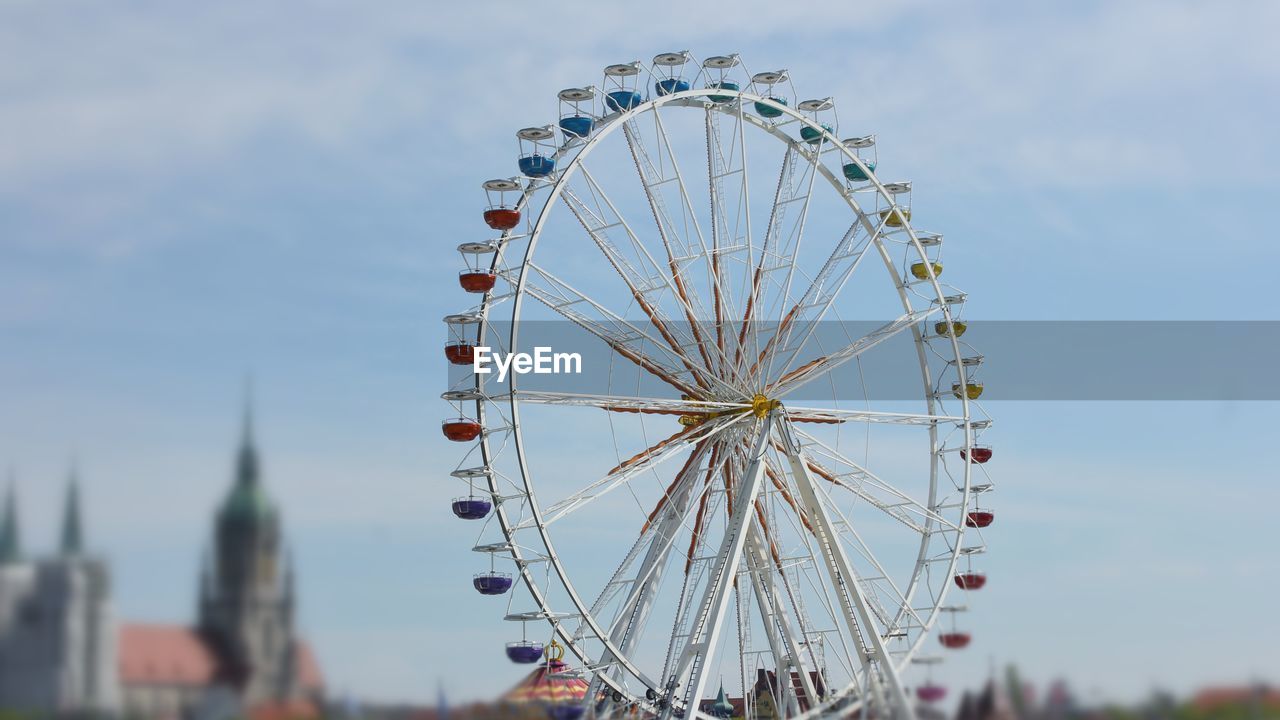 LOW ANGLE VIEW OF FERRIS WHEEL IN SKY