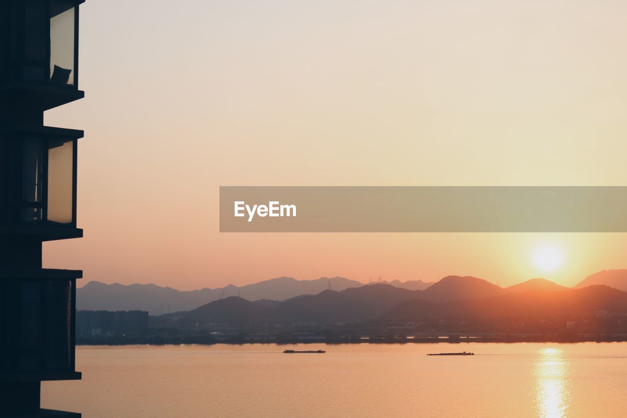 Scenic view of lake against sky during sunset