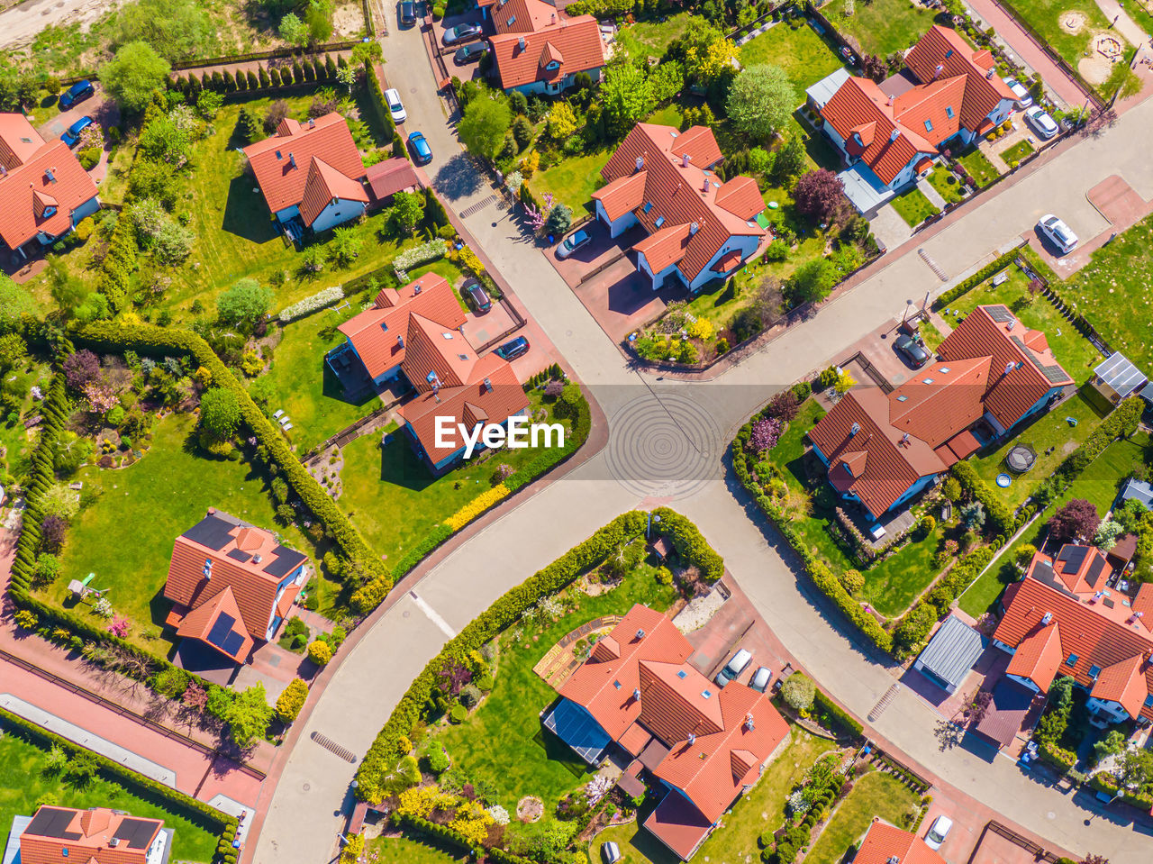 Aerial view of luxury upscale residential neighborhood gated community street real estate single