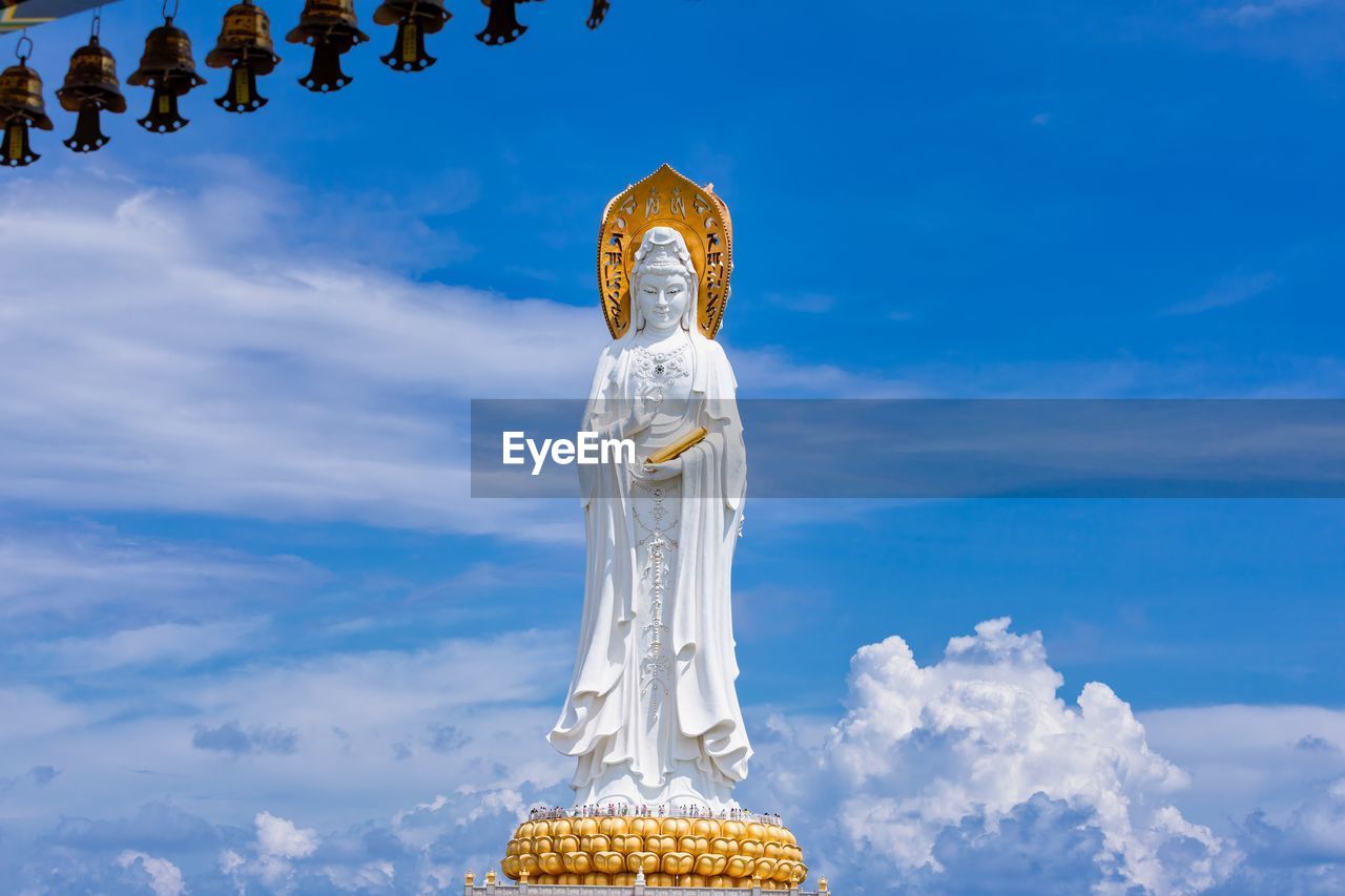 STATUE OF CROSS AGAINST SKY